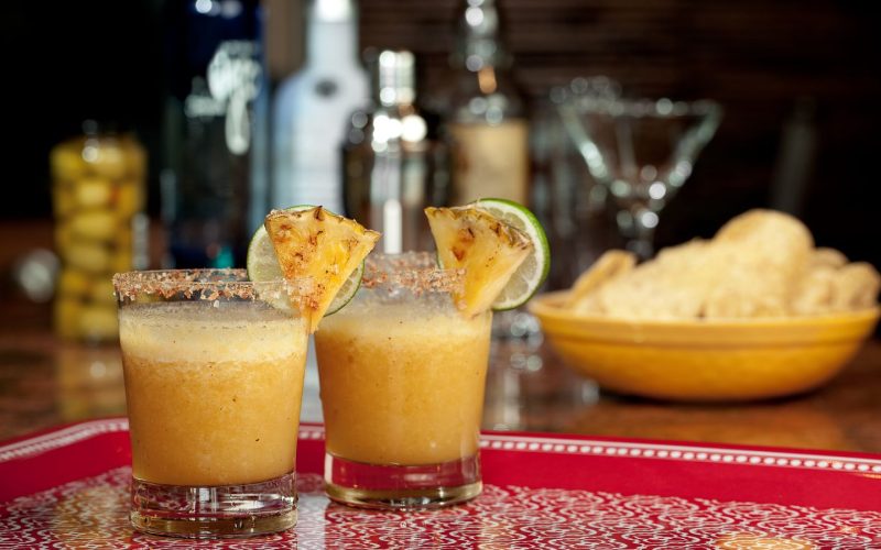 Two,Blended,Pineapple,Margaritas,Sit,Ready,To,Serve,With,Chips